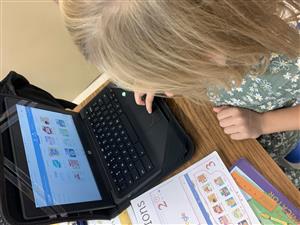 First grader using Chromebook