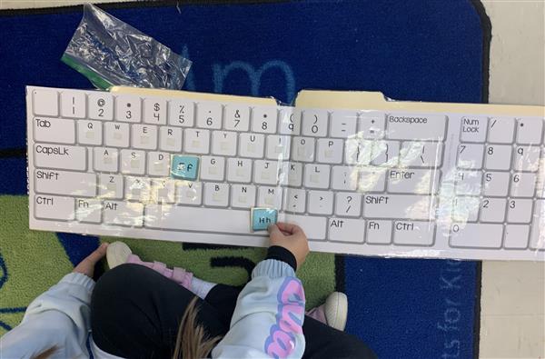 Placing our letters on the keyboard like a puzzle using Velcro.